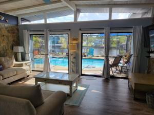 a living room with a view of a pool at WaterFront Mid Century Cottage - Close to beach - 2 BR 3 BA in Ruskin