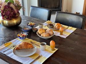 a table with plates of food and eggs on it at Casas Cerejas in Serra de Mangues