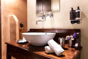 a bathroom with a bowl sink on a wooden counter at Ktima Bellou in Ágios Dimítrios