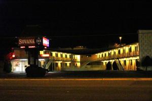 a building lit up at night on a street at Sovana Inn in Medford
