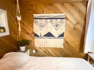 a bedroom with a bed and a rug hanging on a wall at Boise White Water Guest House in Boise