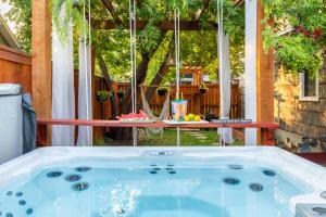 a hot tub in a backyard with a table at Boise White Water Guest House in Boise