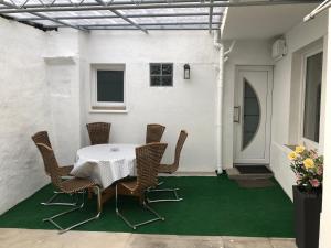 eine Terrasse mit einem Tisch und Stühlen auf einer grünen Etage in der Unterkunft Ferienhaus Herzblume in Cochem