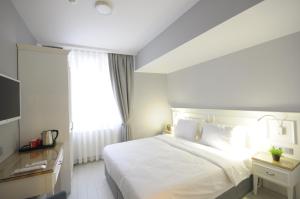 a hotel room with a bed and a desk at Ada Home Istanbul in Istanbul
