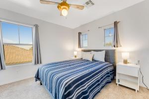 a bedroom with a bed and two windows at Rancho Relaxo in Avondale +27 photos
