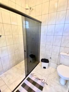 a bathroom with a shower and a toilet at Terra Hostel e Pousada in Lençóis