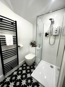 a bathroom with a glass shower and a toilet at 3 West End Boutique Apartment in Bowness-on-Windermere +22 photos