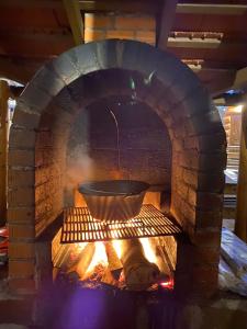 a large brick oven with a pot in it at Casa Bogát Ház in Harghita-Băi