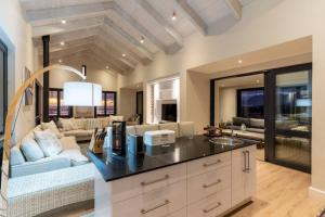 a kitchen and living room with a couch and a table at Hermanus Beach House at CShine in Hermanus