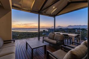 a living room with a view of the ocean at Hermanus Beach House at CShine in Hermanus