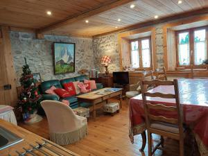 a living room with a christmas tree in it at Les Sapins Blancs in Vacheresse