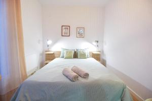a bedroom with a bed with two towels on it at City apartment with workspace, rooftop & parking in Tarifa