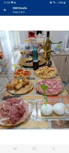 a table with many plates of food and bottles of wine at B&B Renella in Caserta