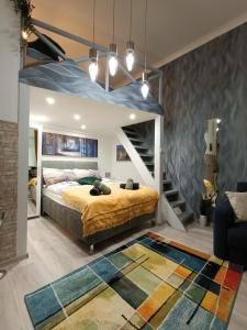 a bedroom with a large bed and a staircase at Suzan's apartment in the heart of Budapest in Budapest