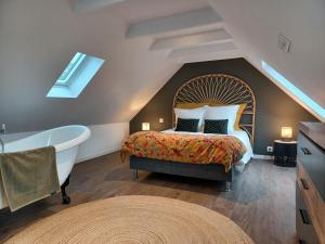 a bedroom with a large bed and a bathtub and a bed with a large at tourmaline in Concarneau