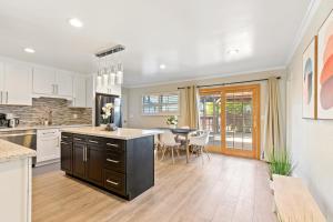 a kitchen and dining room with a table and chairs at @ Marbella Lane - Modern Refreshing Home in San Mateo