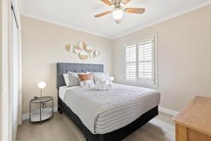 a bedroom with a bed with a ceiling fan at @ Marbella Lane - Modern Refreshing Home in San Mateo