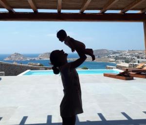 a statue of a woman holding a baby at Villa Agapi, 2 min walk to the beach & heated pool, by Red Windmill Villas in Kalafatis