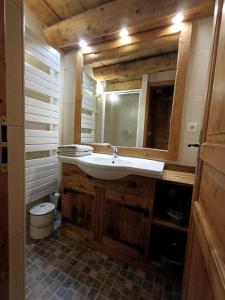 a bathroom with a sink and a mirror at Les Sapins Blancs in Vacheresse