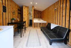 a living room with a couch and a bed at Woodshed Pod in Fort William