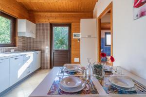 a kitchen with a table with plates on it at Agriturismo Kypeiros in Noto
