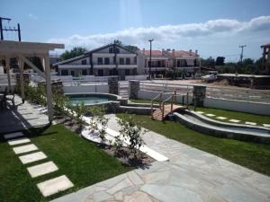 a backyard with a swimming pool and a playground at Villa Nikiti View in Nikiti