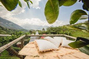 a hammock on the top of a house with a view at Cerro Tusa Glamping in Titiribí +66 photos