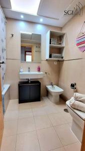 a bathroom with a sink and a toilet at SUNSET Chill Out- Torres D' Oboe in Benidorm