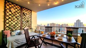 a balcony with a table and a view of a city at SUNSET Chill Out- Torres D' Oboe in Benidorm