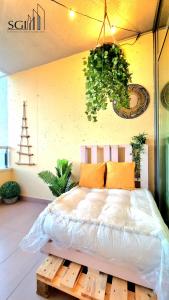 a bedroom with a bed on a wooden platform at SUNSET Chill Out- Torres D' Oboe in Benidorm