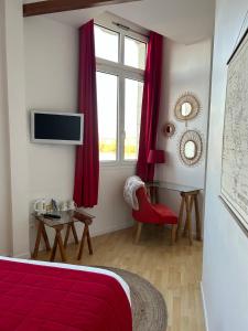 a bedroom with a red bed and a window at Rive Gauche in Saumur