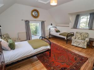 a bedroom with a bed and a living room at The Coach House in Gloucester