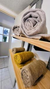 a bunch of towels on shelves in a room at La petite forêt in Romorantin