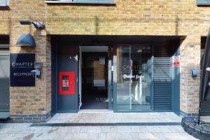 a entrance to a brick building with a red door at Premium Studios at Chapter Westminster in London minutes away from The Big Ben in London
