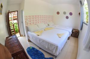 a bedroom with a large white bed in a room at João Praia Hotel in Marau