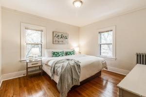 a bedroom with a large bed and two windows at NEWHOST-Victorian Pintrest Style 15min to Downtown in Detroit