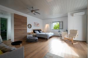 a bedroom with a bed and a ceiling fan at Villa in Kamares, Sifnos in Kamares