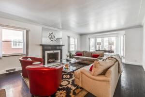 a living room with two couches and a fireplace at The Parkside / University District/15m to Downtown in Detroit