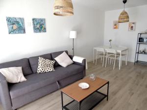 a living room with a couch and a table at Mi Lugar FTV in Corralejo