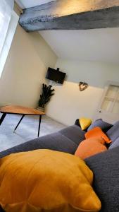 a living room with a couch and a table at La petite forêt in Romorantin