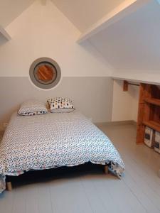 a bedroom with a bed in a white room at Maison a la campagne in Saint-Pierre-de-Chevillé