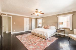 a bedroom with a bed and a ceiling fan at The Parkside / University District/15m to Downtown in Detroit