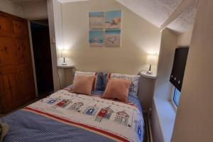 a bedroom with a bed with two pillows on it at Seaview cottage North Wales in Penmaen-mawr