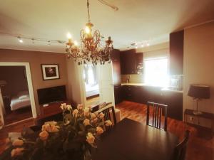 a dining room with a table and a chandelier at Bryggen in Bergen