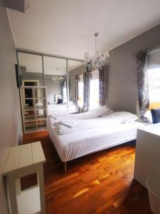 a bedroom with two beds and a large mirror at Bryggen in Bergen