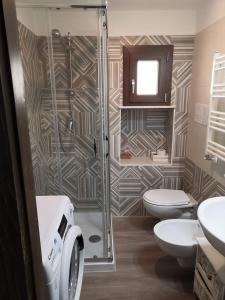 a bathroom with a shower and a toilet and a sink at Lo Stemma Guest House in Melfi +34 photos