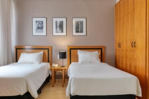 Cama ou camas em um quarto em Mercure Belo Horizonte Savassi