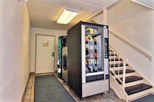 a refrigerator in a hallway next to a staircase at Motel 6-Merrillville, IN in Merrillville