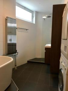 a bathroom with a tub and a toilet and a sink at Hotel Tongerlo in Roosendaal +92 photos