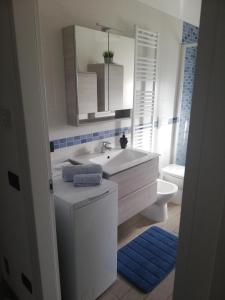 a bathroom with a sink and a toilet and a mirror at G.V. Suite Torino - Bilocale in Turin